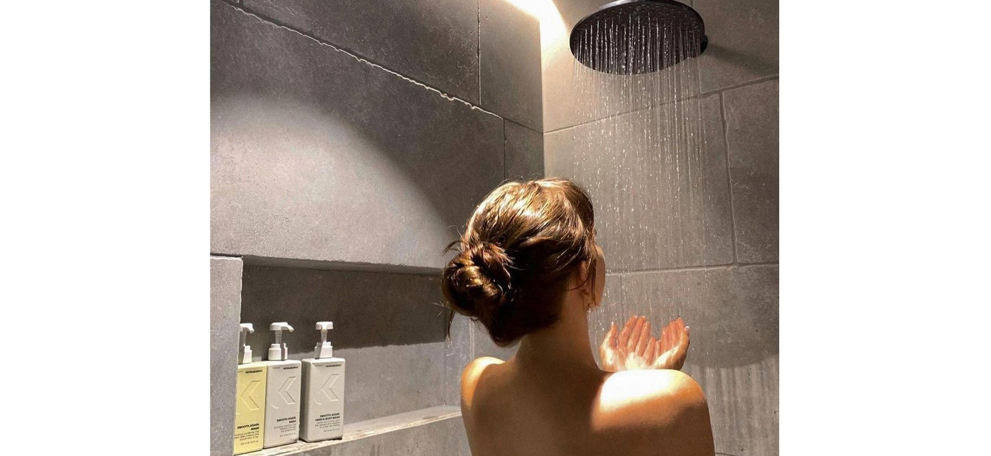 Elegant updo before washing with KEVIN.MURPHY shampoo in a modern shower setting.